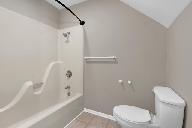 bathroom with tile patterned flooring, toilet, and tub / shower combination