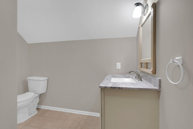 bathroom with toilet, vanity, and vaulted ceiling