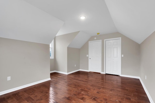 additional living space featuring dark hardwood / wood-style floors and lofted ceiling