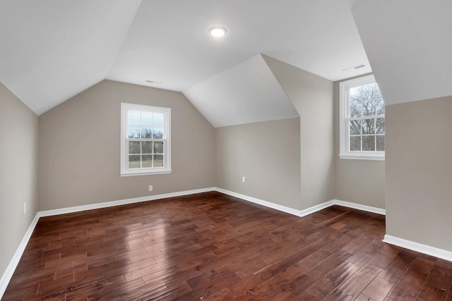 additional living space with dark hardwood / wood-style flooring and lofted ceiling