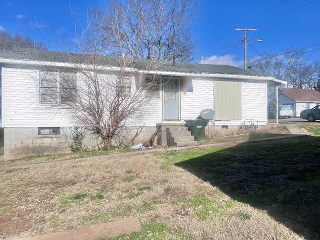 rear view of property featuring a yard