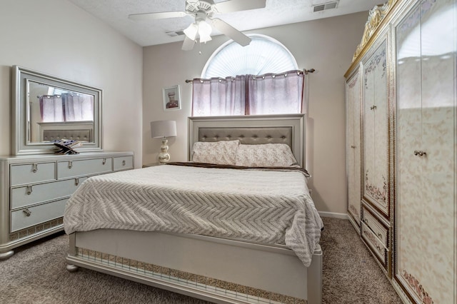 bedroom with ceiling fan and dark colored carpet