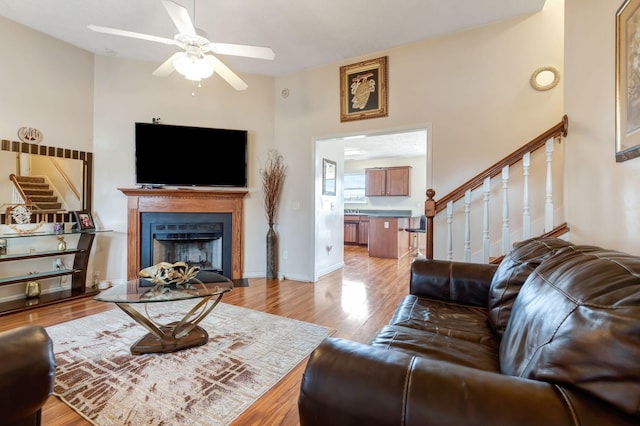 living room featuring light wood-type flooring and ceiling fan