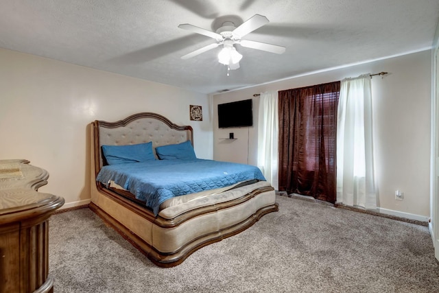 carpeted bedroom with multiple windows, ceiling fan, and a textured ceiling