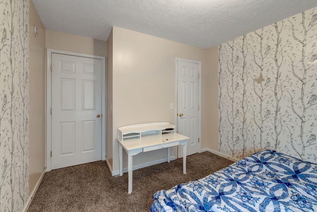 carpeted bedroom with a textured ceiling