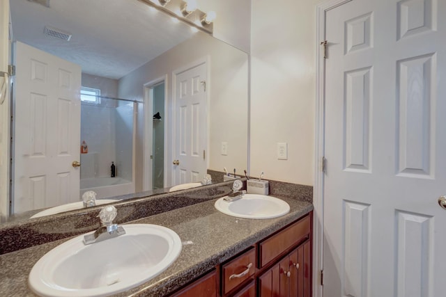 bathroom featuring vanity and bathing tub / shower combination