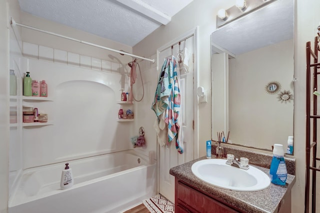 bathroom featuring a textured ceiling, hardwood / wood-style floors, vanity, and  shower combination