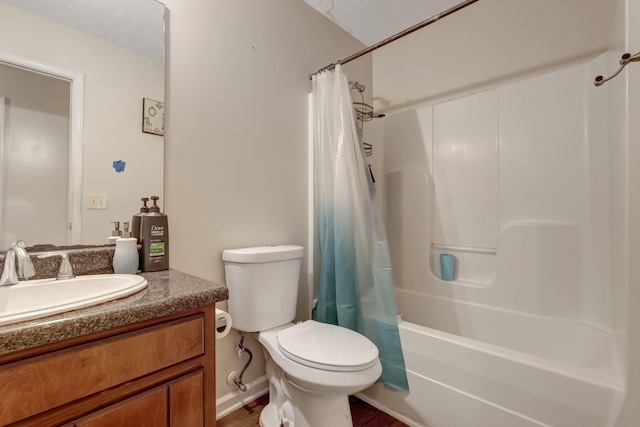 full bathroom featuring hardwood / wood-style floors, vanity, toilet, and a textured ceiling