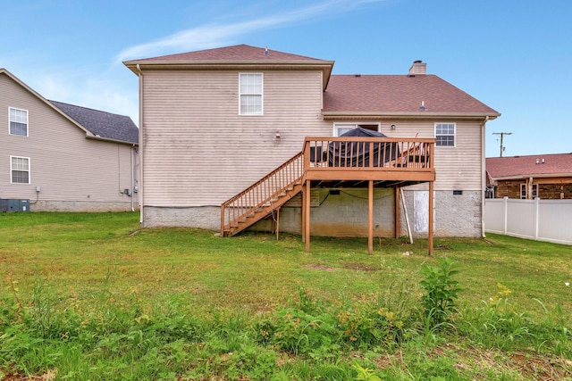 back of property featuring a deck, central AC unit, and a lawn