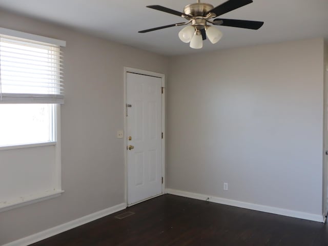 unfurnished room featuring ceiling fan and dark wood-type flooring