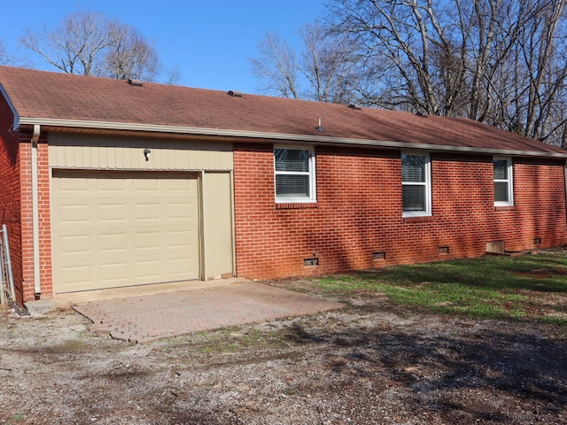 view of side of home featuring a garage