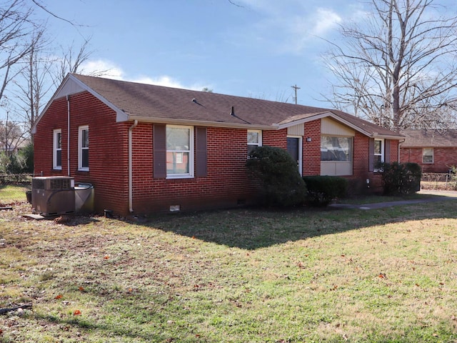 exterior space with a front yard and central AC unit