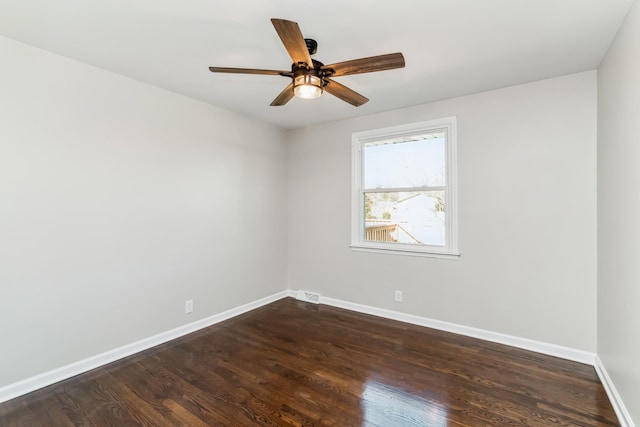 empty room with dark hardwood / wood-style flooring and ceiling fan