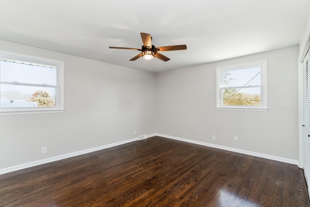 unfurnished room with ceiling fan and dark wood-type flooring