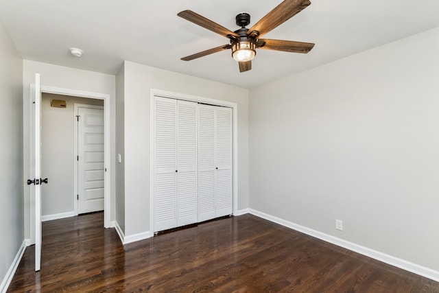 unfurnished bedroom featuring ceiling fan, dark hardwood / wood-style flooring, and a closet