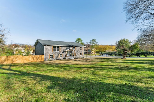 rear view of house featuring a lawn