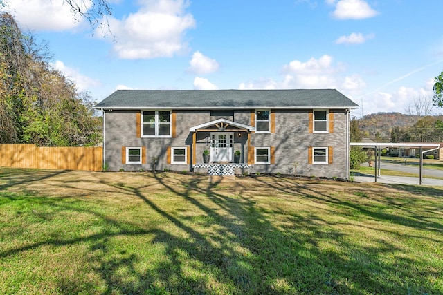 raised ranch with a front yard