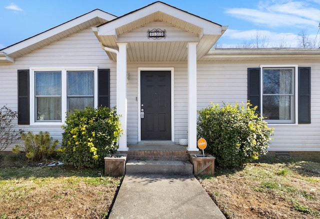 doorway to property featuring a lawn