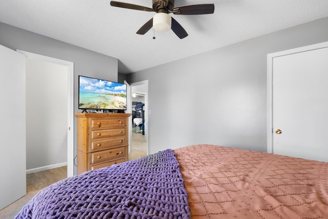 bedroom with a textured ceiling and ceiling fan