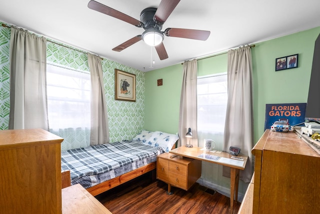 bedroom featuring multiple windows, dark hardwood / wood-style flooring, and ceiling fan