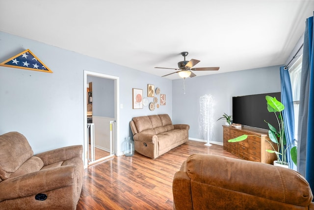 living room with hardwood / wood-style flooring and ceiling fan