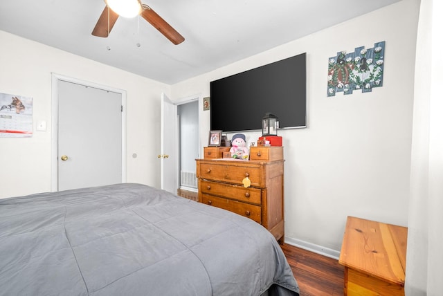 bedroom with ceiling fan, wood-type flooring, and a closet