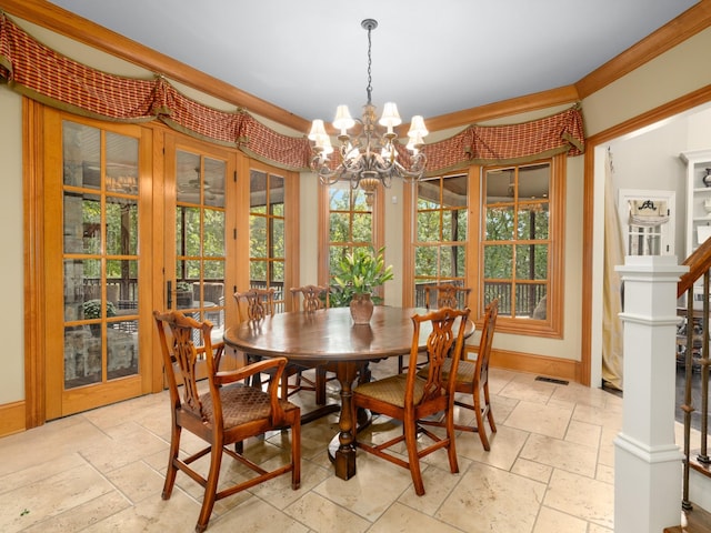 dining space featuring french doors, crown molding, and a chandelier