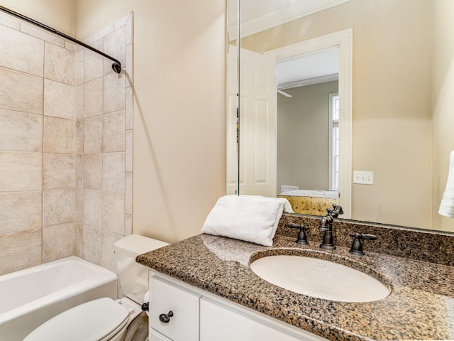 full bathroom featuring vanity, toilet, tiled shower / bath, and ornamental molding