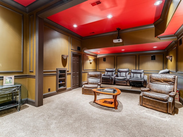 carpeted home theater room with ornamental molding