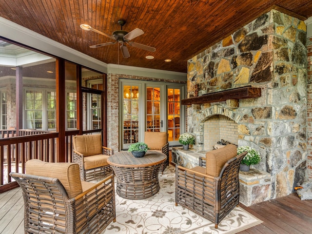 sunroom / solarium with a healthy amount of sunlight, ceiling fan, and wood ceiling