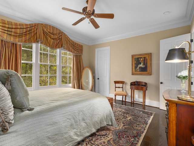 bedroom with ceiling fan, dark hardwood / wood-style floors, and crown molding