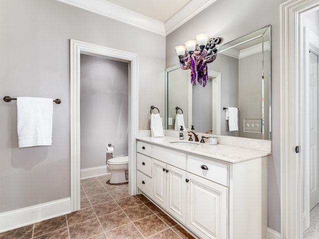 bathroom with toilet, vanity, and ornamental molding