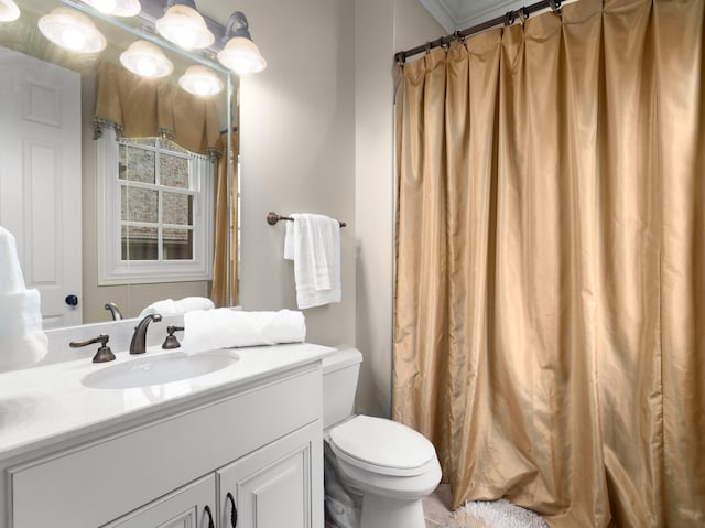 bathroom with walk in shower, vanity, ornamental molding, and toilet