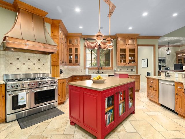 kitchen with custom range hood, stainless steel appliances, sink, decorative light fixtures, and a center island