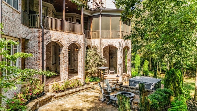 view of patio featuring a sunroom