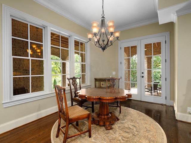 dining area featuring a chandelier, french doors, dark hardwood / wood-style flooring, and crown molding