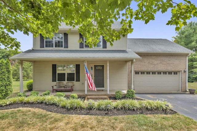 view of front of house featuring a porch and a garage