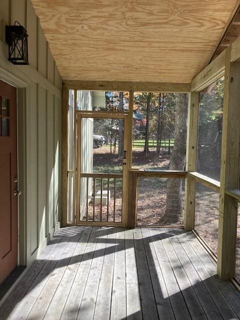 unfurnished sunroom featuring wooden ceiling and lofted ceiling