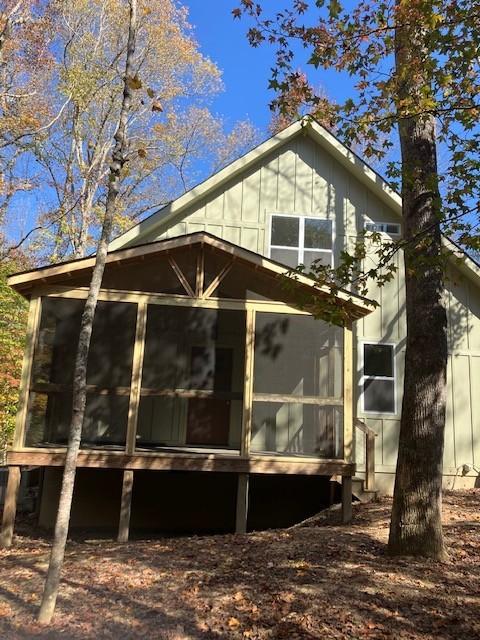 view of home's exterior with a sunroom