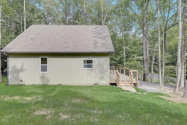 view of side of home featuring a lawn and a deck