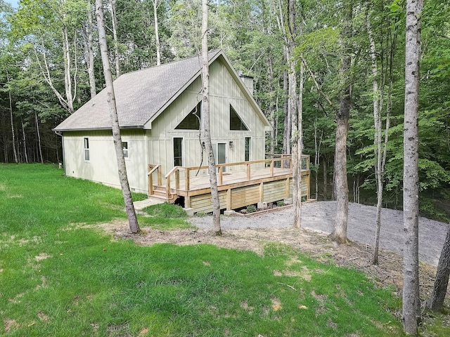 exterior space featuring a wooden deck and a front lawn