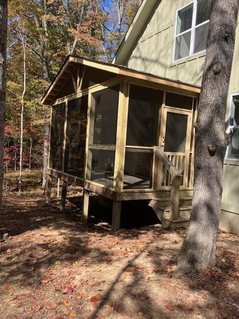 view of property exterior featuring a sunroom