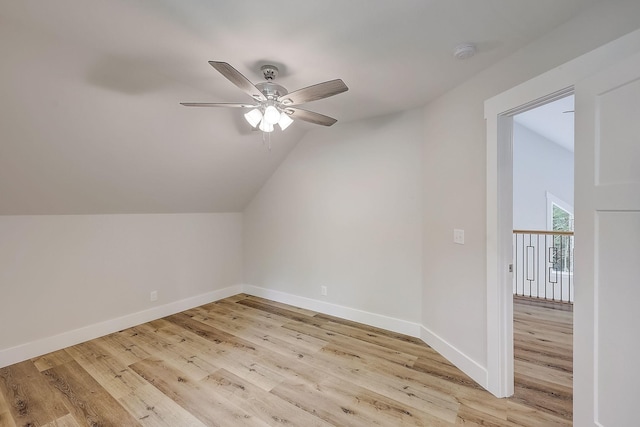 additional living space with ceiling fan, light hardwood / wood-style floors, and vaulted ceiling