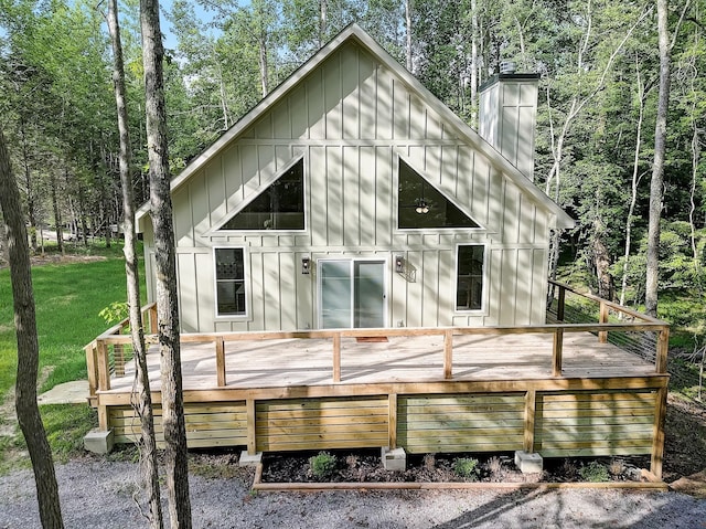 rear view of property with a lawn and a wooden deck