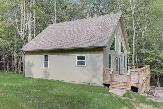 view of side of home with a yard and a wooden deck