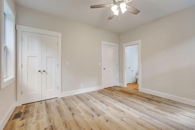 unfurnished bedroom with ceiling fan and light wood-type flooring