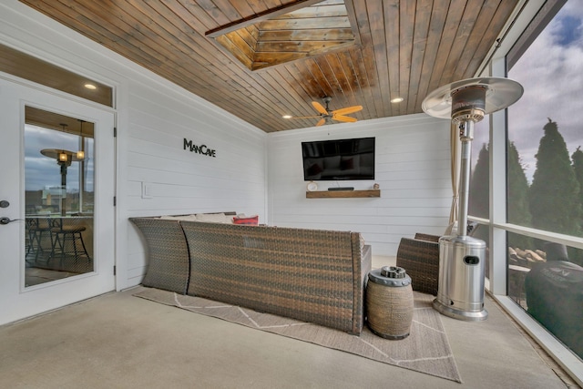 sunroom / solarium with a skylight, ceiling fan, and wooden ceiling