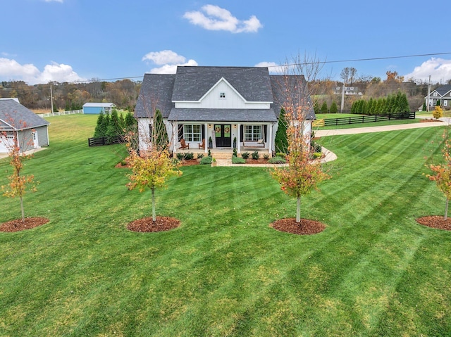 view of front of house featuring covered porch and a front lawn