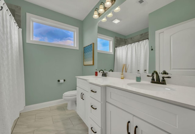 bathroom with walk in shower, vanity, and toilet