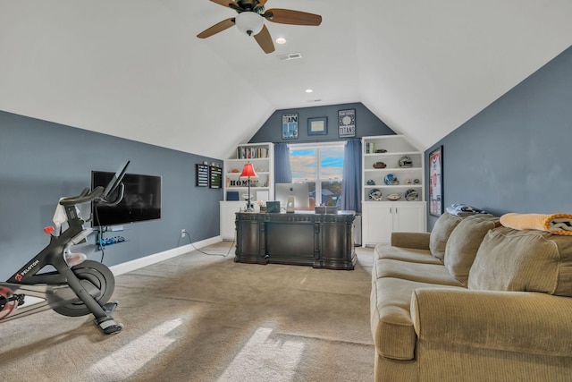 carpeted living room with ceiling fan, vaulted ceiling, and built in shelves